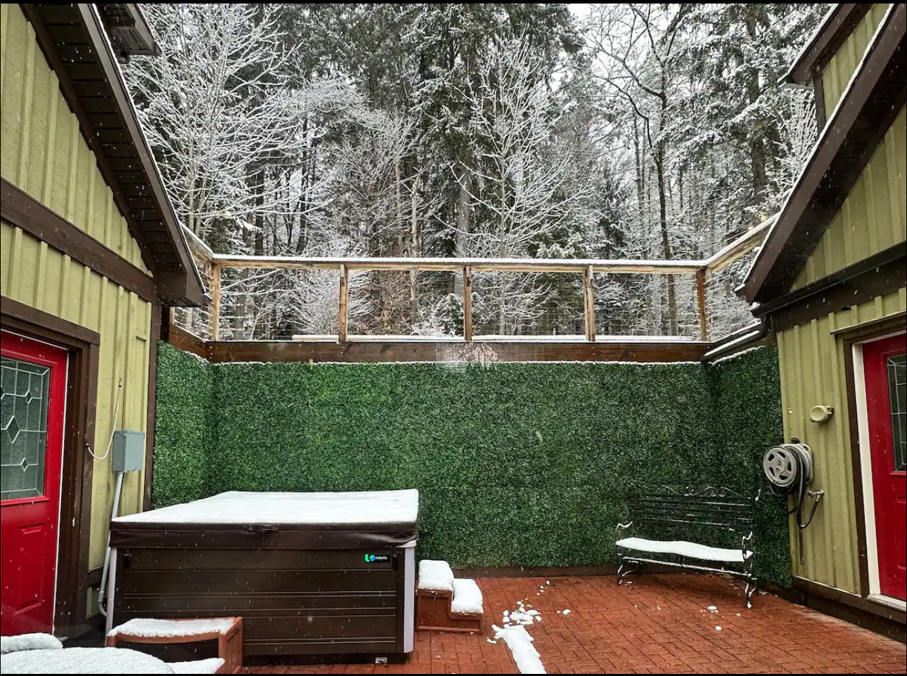 The lodge’s private hot tub courtyard surrounded by snowy trees
